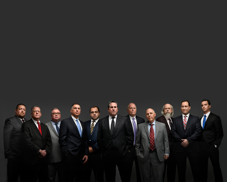 Group photo of the Law Offices of Jonathan F. Marshall with a gray background